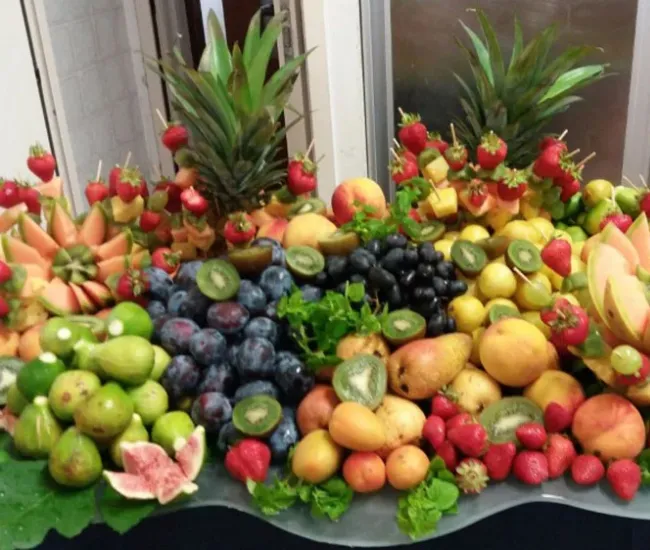 Un colorato assortimento di frutta fresca con decorazioni di ananas e fragole.
